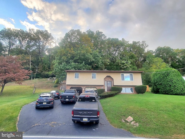 raised ranch with a front yard