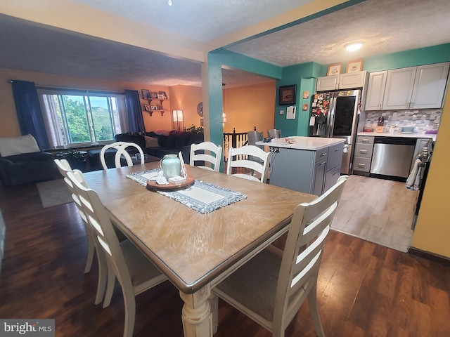 dining area featuring hardwood / wood-style floors and a textured ceiling