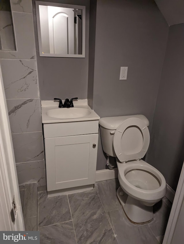 bathroom featuring vanity and toilet