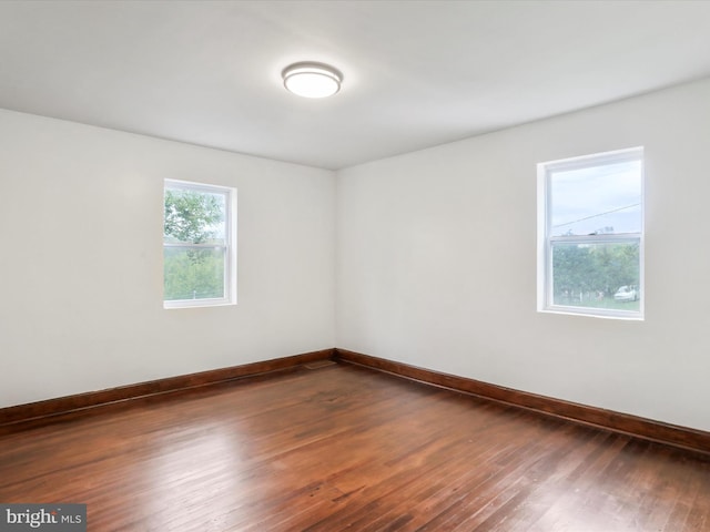 spare room featuring dark hardwood / wood-style flooring