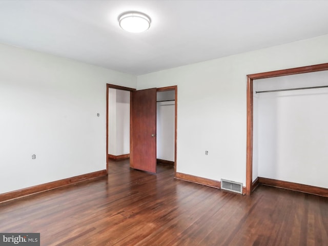 unfurnished bedroom featuring dark wood-type flooring