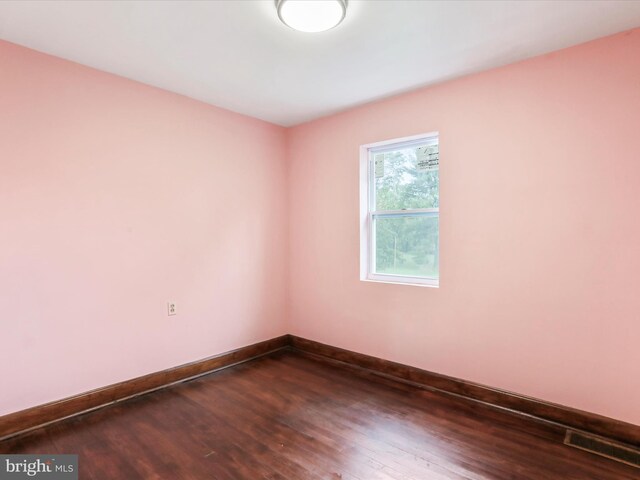 unfurnished room featuring wood-type flooring