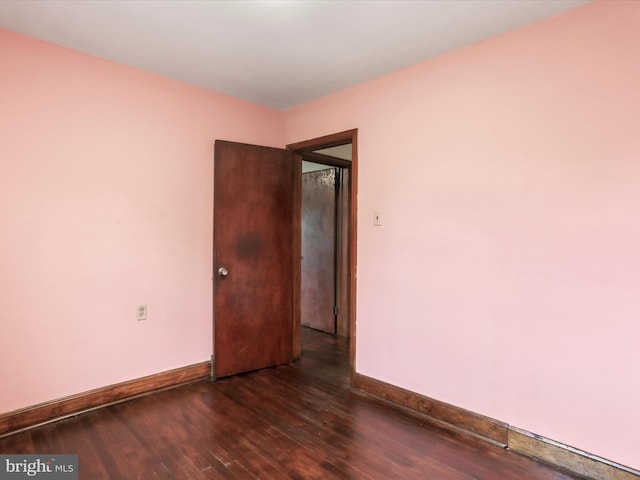 empty room featuring dark wood-type flooring