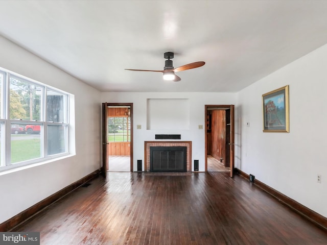 unfurnished living room with ceiling fan, a fireplace, and dark hardwood / wood-style floors