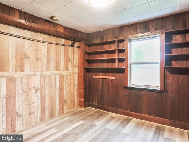 interior space featuring wooden walls and wood-type flooring