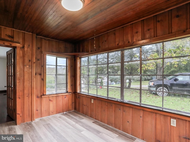 unfurnished sunroom featuring wood ceiling