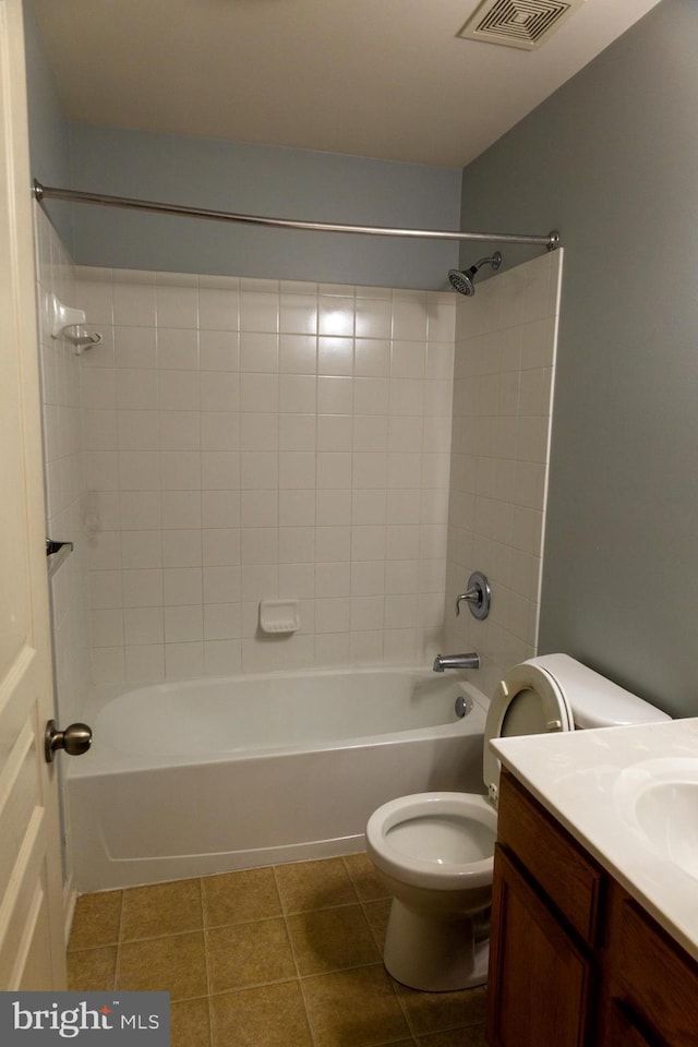 bathroom with visible vents, toilet, vanity, shower / tub combination, and tile patterned floors