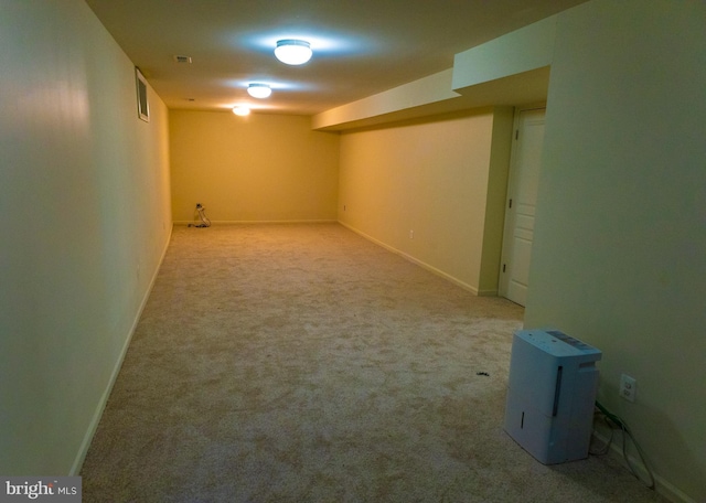 finished basement featuring carpet, visible vents, and baseboards