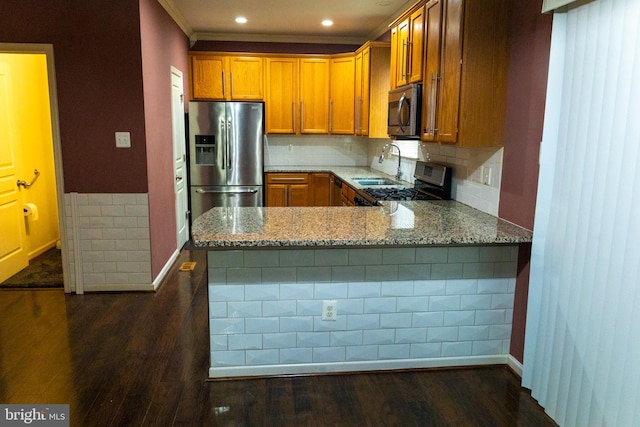 kitchen featuring appliances with stainless steel finishes, dark wood-type flooring, and light stone countertops