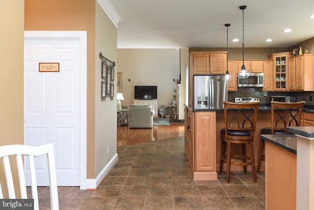 kitchen featuring pendant lighting, dark hardwood / wood-style flooring, a kitchen breakfast bar, stainless steel appliances, and backsplash