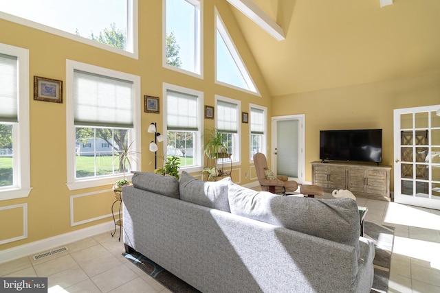 tiled living room with a high ceiling