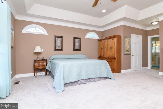 bedroom with ornamental molding, light colored carpet, ensuite bathroom, and ceiling fan