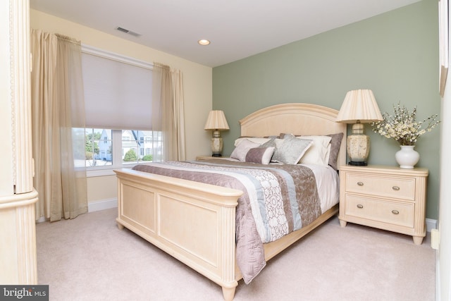 bedroom with light colored carpet