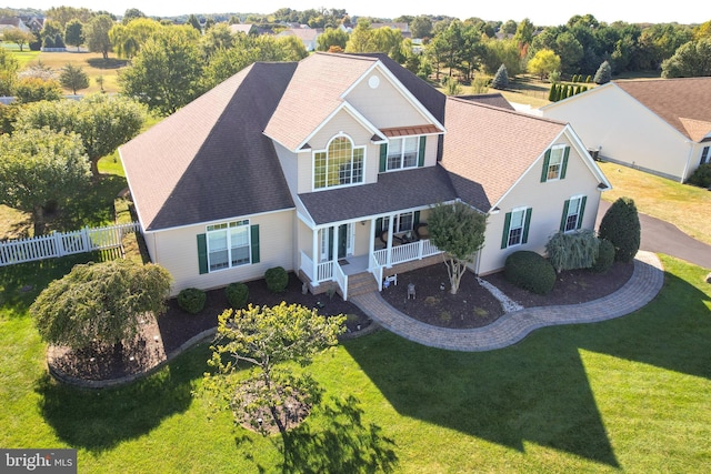 view of front of home with a front yard and covered porch