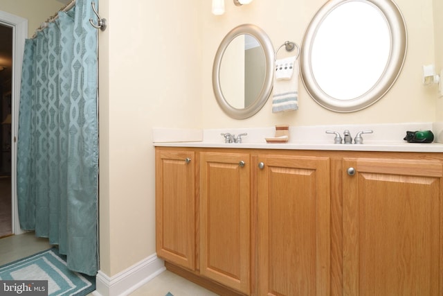 bathroom with tile patterned floors and vanity