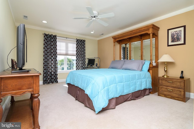 bedroom featuring ornamental molding, ceiling fan, and light colored carpet