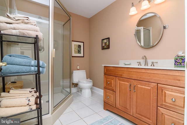 bathroom with tile patterned flooring, walk in shower, vanity, and toilet