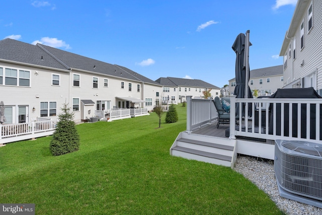 view of yard with a wooden deck and central AC