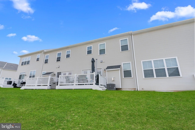 back of house featuring a wooden deck, a lawn, and central AC