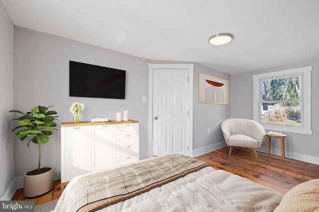 bedroom with dark wood-type flooring