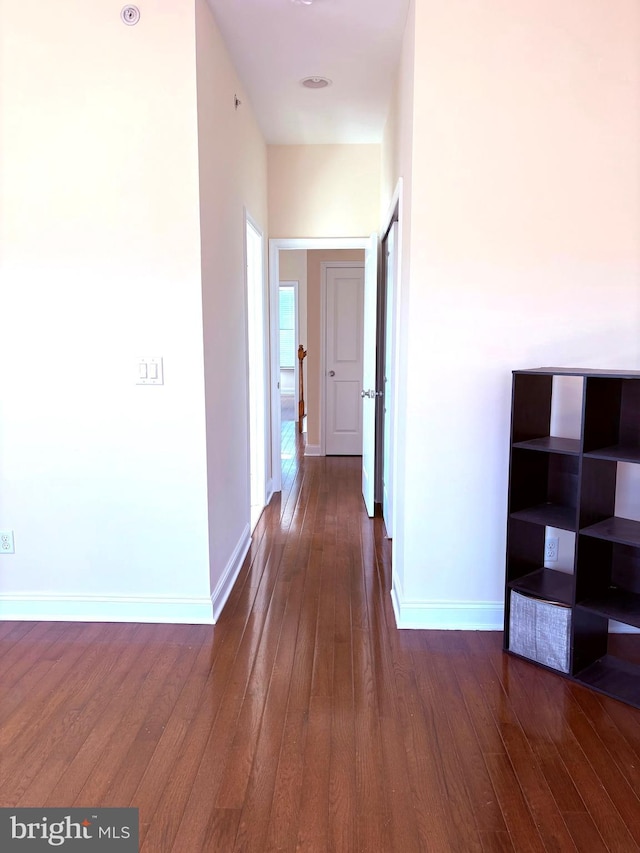 hallway with dark hardwood / wood-style flooring