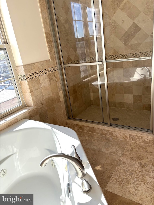 bathroom with tile walls, sink, and plus walk in shower