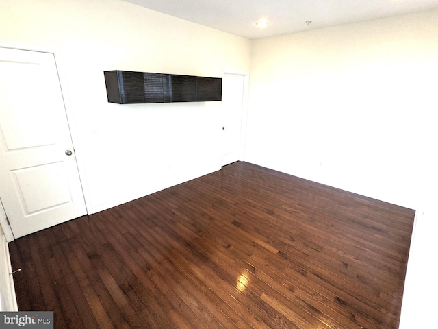 empty room featuring dark hardwood / wood-style flooring