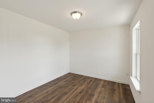 empty room with dark hardwood / wood-style floors