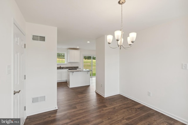 interior space with a chandelier and dark wood-type flooring