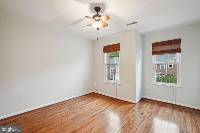 empty room featuring ceiling fan and light hardwood / wood-style flooring