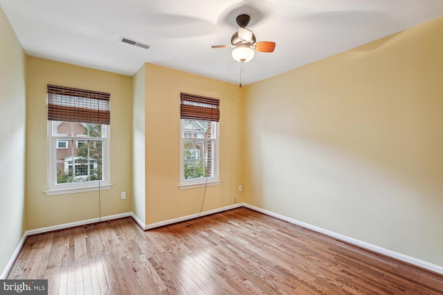 unfurnished room featuring ceiling fan, light hardwood / wood-style flooring, and plenty of natural light