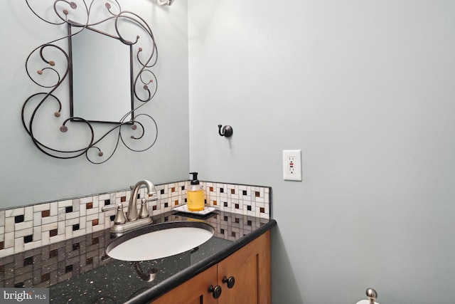 bathroom featuring vanity and backsplash