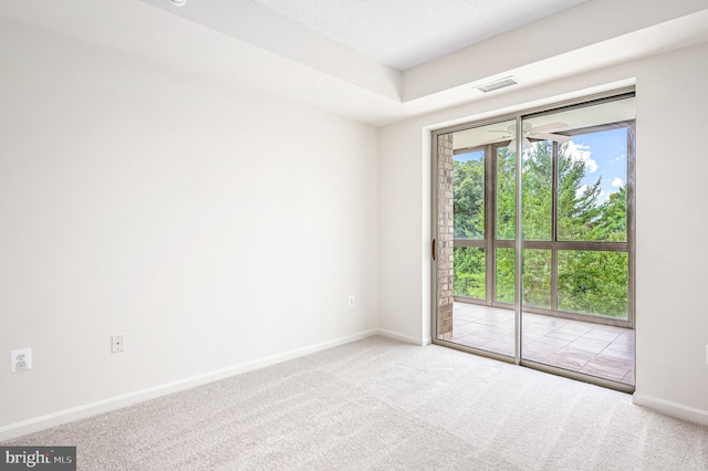 empty room with a textured ceiling, carpet flooring, and ceiling fan