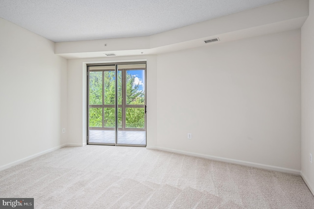 unfurnished room featuring carpet floors and a textured ceiling