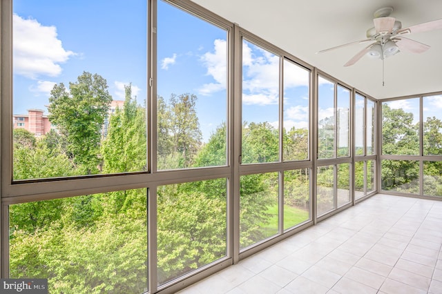 unfurnished sunroom featuring ceiling fan