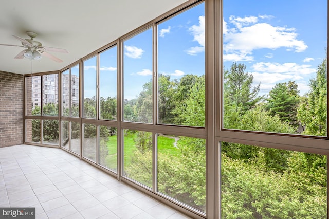 unfurnished sunroom with ceiling fan and plenty of natural light