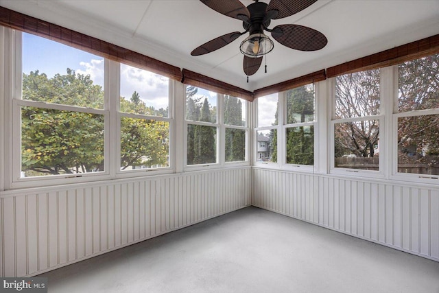 unfurnished sunroom with ceiling fan