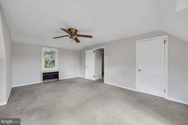 unfurnished living room with carpet, vaulted ceiling, heating unit, and ceiling fan