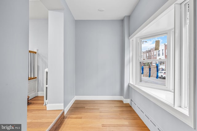 interior space with a baseboard radiator and light hardwood / wood-style floors