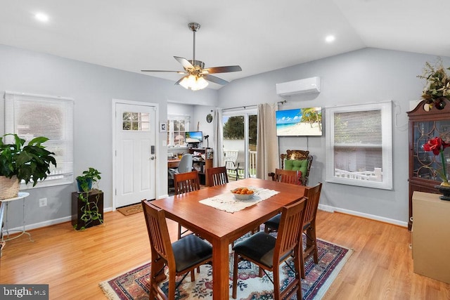 dining area featuring light hardwood / wood-style flooring, lofted ceiling, ceiling fan, and a wall mounted AC