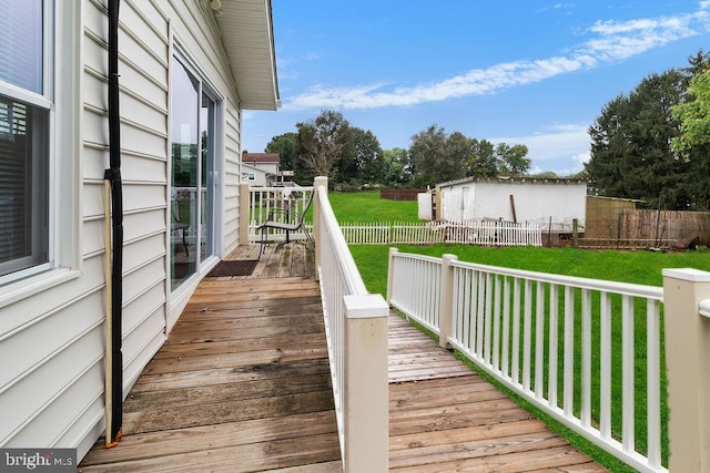 wooden terrace with a shed and a yard