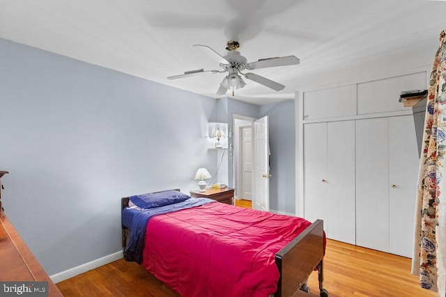 bedroom featuring wood-type flooring, ceiling fan, and a closet