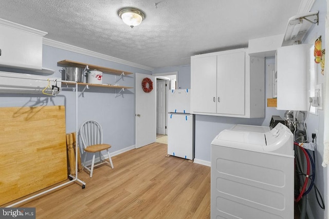 kitchen featuring white cabinets, ornamental molding, white fridge, independent washer and dryer, and light hardwood / wood-style floors