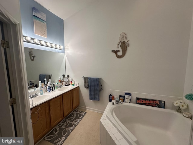 bathroom with vanity and tiled bath