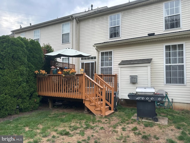 back of house with a lawn and a deck