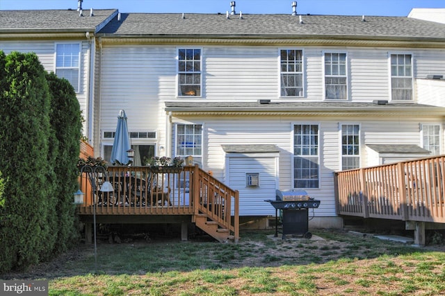 back of property featuring a yard and a wooden deck