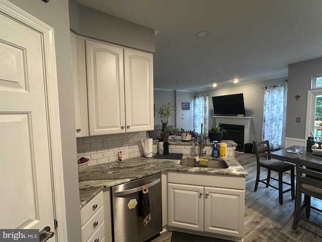 kitchen with dishwasher, dark hardwood / wood-style floors, white cabinetry, and sink