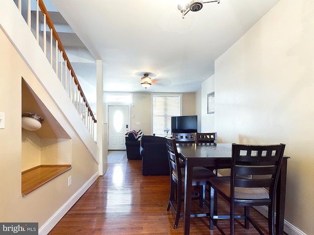 dining space with dark hardwood / wood-style floors and ceiling fan