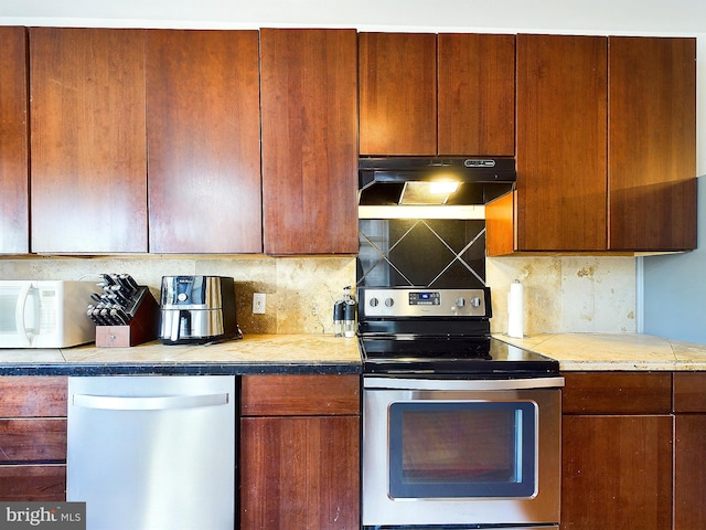 kitchen featuring backsplash and stainless steel appliances