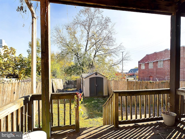 wooden terrace featuring a storage shed